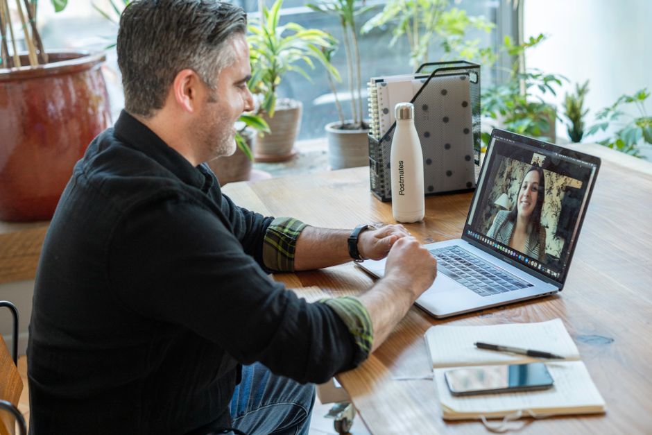 A short video call between two people at their desks